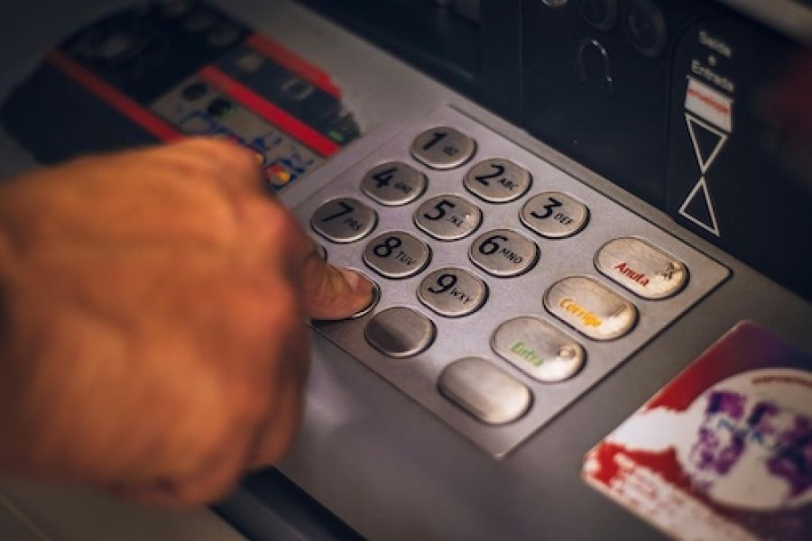 Person fixing an ATM.
