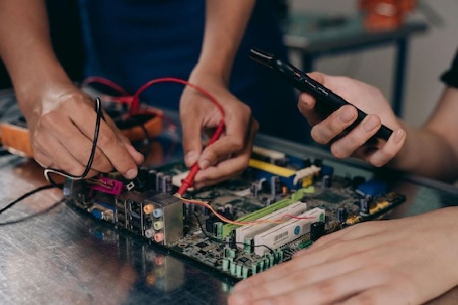 Someone fixing a circuit board.