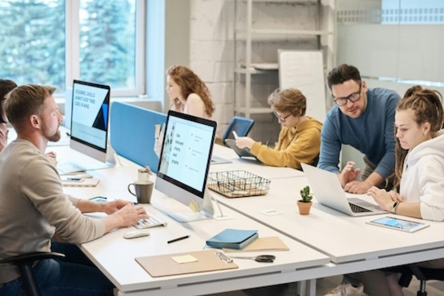 A group of people at a set of computers.