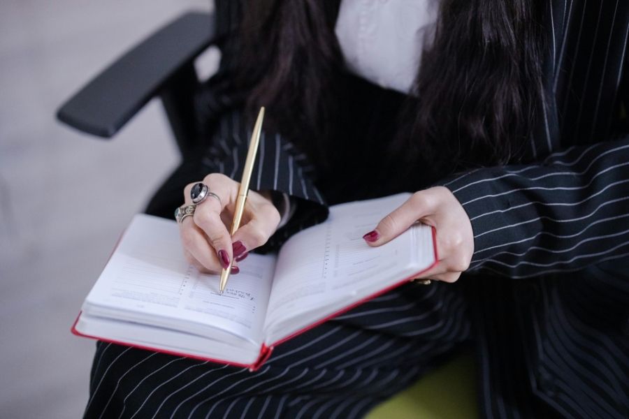 Person writing in an appointment book