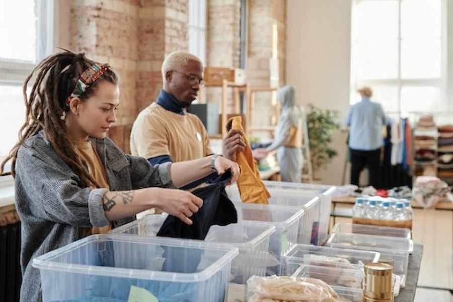 two people sorting through bins