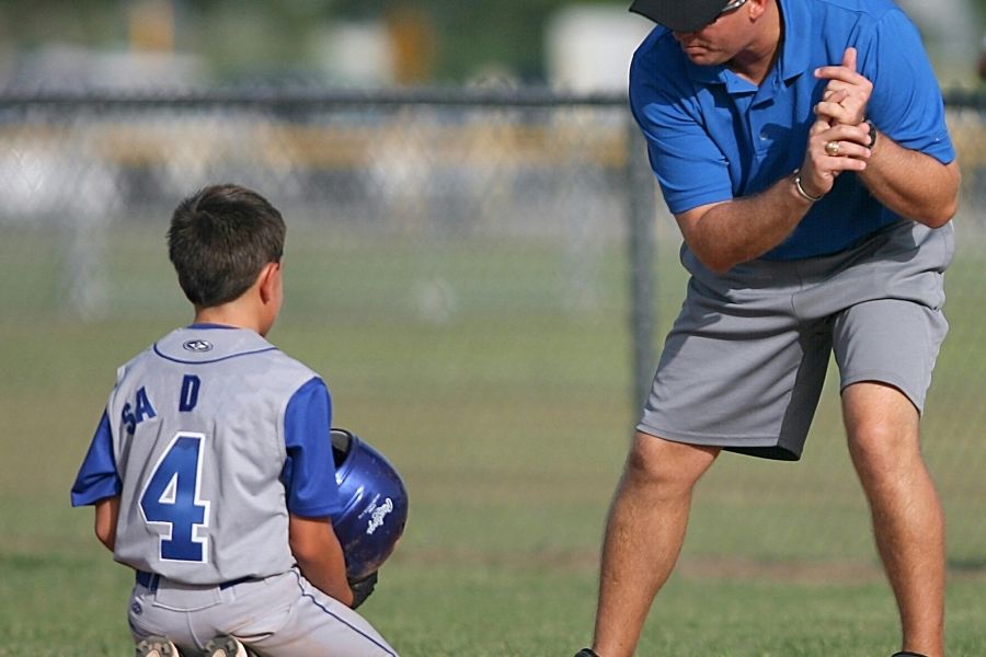 Sport coach working with a child.